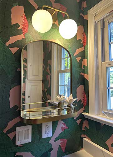 Photo of bathroom with large banana leaf wallpaper on walls